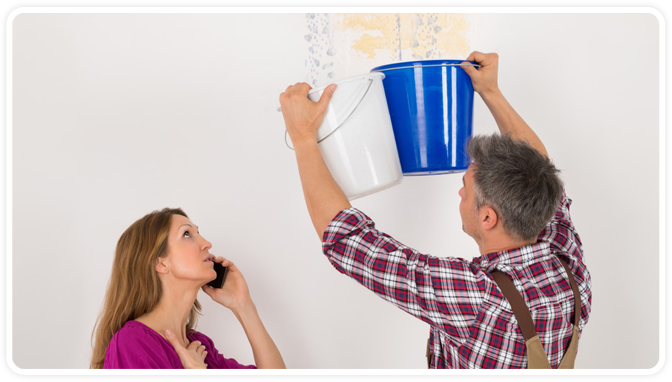 man holding bucket to with water falling from the ceiling and lady calling on the left.